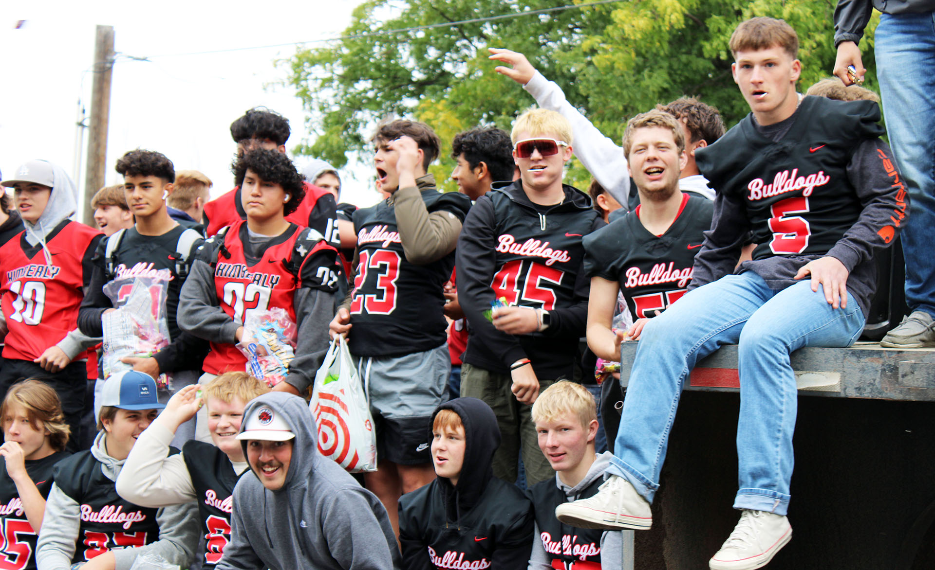 Members of the varsity football team celebrate during the parade on Friday, Sept. 22. | Photo by Jacey Cypriano